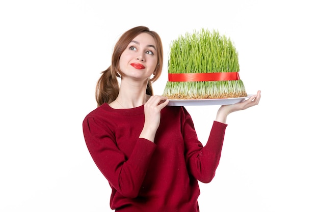 front view young female holding big novruz semeni on white background family spring ethnic performer colours ethnicity concept holiday