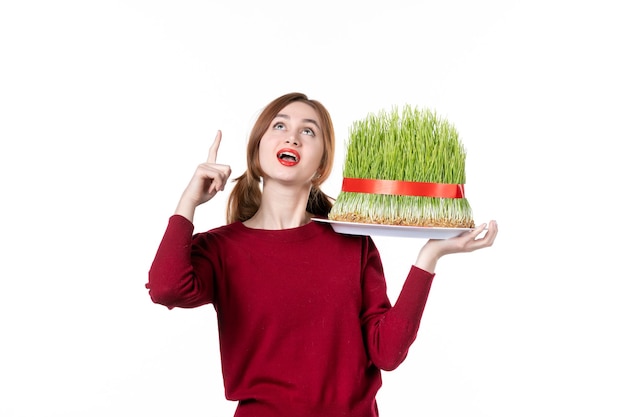 front view young female holding big novruz semeni on white background family spring ethnic performer colours ethnicity concept holidays