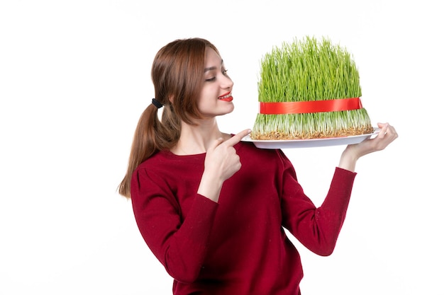 front view young female holding big novruz semeni on white background family spring ethnic performer colours holiday ethnicity