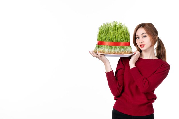 front view young female holding big novruz semeni on white background family spring performer colours ethnicity holiday ethnic