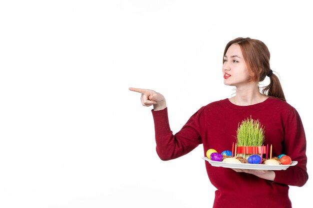 front view young female holding honca with semeni and novruz sweets on white background spring ethnic performer ethnicity holiday concept family