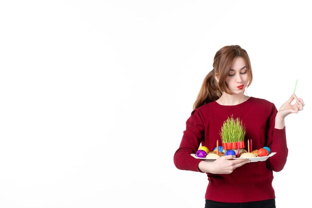 front view young female holding novruz honca on white background spring ethnic performers ethnicity holiday concept family colours