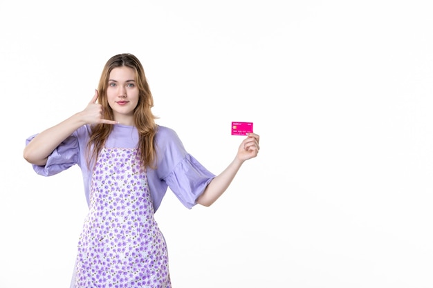 front view young female holding pink bank card on white background money flower grass plant color shopping garden