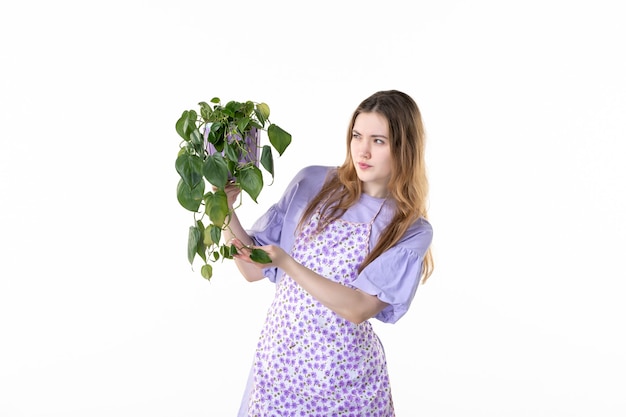 front view young female holding pot with plant on a white background leaf garden grass shopping soil plant woman green job flower