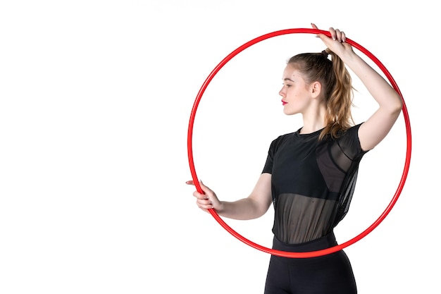 front view young female holding red hula hoop for sport on white background athlete yoga health body sport regime woman