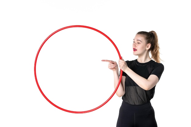 front view young female holding red hula hoop on white background color yoga body lifestyle athlete circus woman health