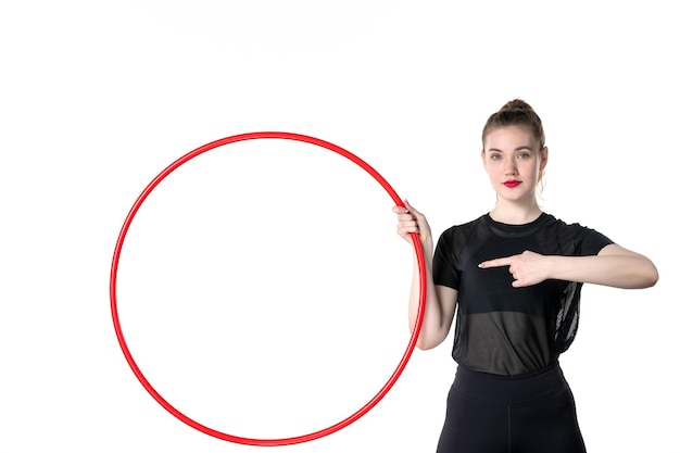 front view young female holding red hula hoop on white background colors yoga body lifestyle athlete circus sport woman health