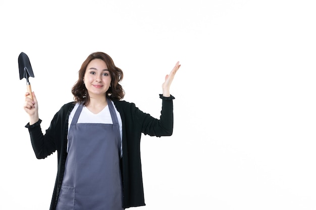 front view young female holding spatula on light background nature tree emotion uniform garden soil flower green woman