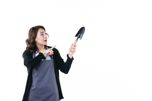 front view young female holding spatula on light background soil nature tree emotion garden green woman uniform flower