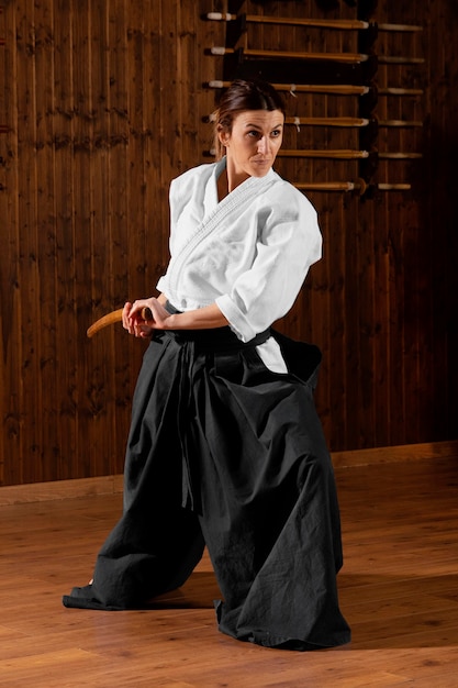 Front view of young female martial arts trainee in the practice\
hall