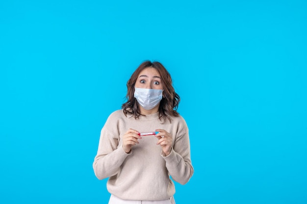 front view young female in mask with flask on blue background medical virus covid pandemic disease science health isolation