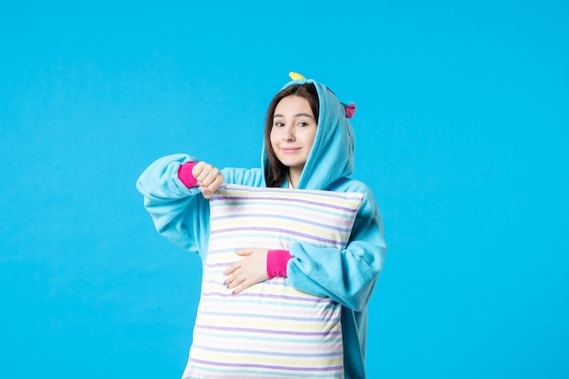 front view young female in pajamas for pajama party holding pillow on blue background bed woman night rest nightmare late fun dream sleep