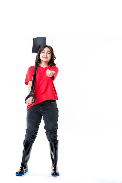 front view young female in red shirt holding black shovel on white background soil work woman job ground emotion nature