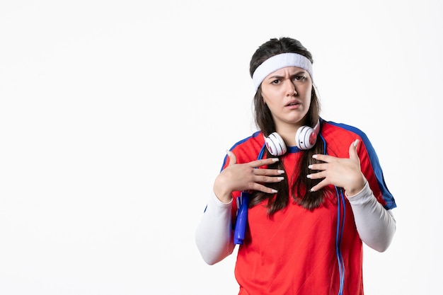 Front view young female in sport clothes with skipping ropes on white wall