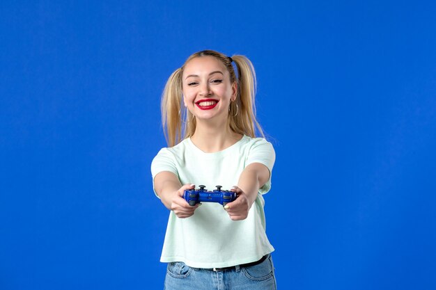 front view young female with gamepad on blue background joyful player youth virtual adult winning internet video sofa