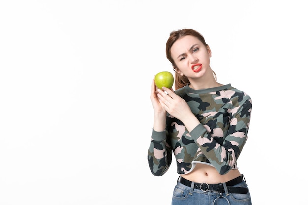 Front view young female with green apple on white background skin wellness horizontal healthcare fruit juice diet human