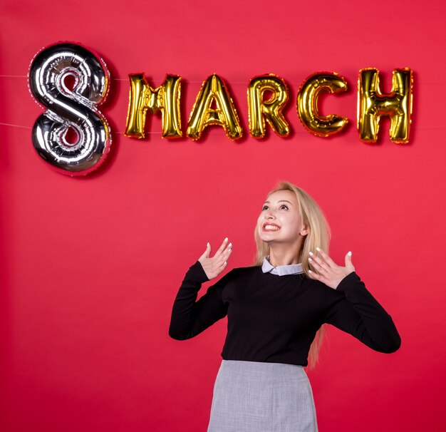 front view young female with march decoration on red background luxurious equality feminine womans day sensual love passion holiday