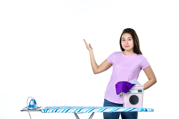 front view young housewife with clothes and ironing board on the white background dry emotion housework laundry clean woman color work