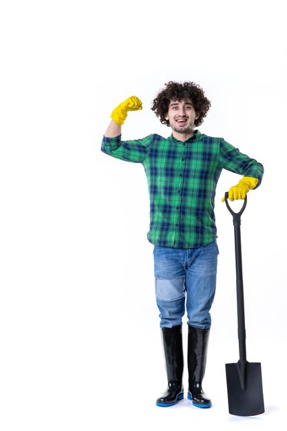 front view young male gardener holding shovel on white background grass flower water soil field job tree garden