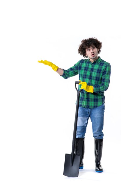 front view young male gardener holding shovel on the white background grass flower water soil garden field job tree