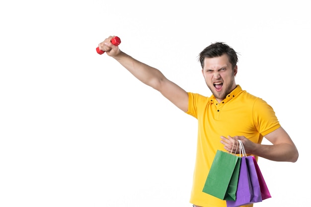 Front view young male holding dumbbell and packages on white background uniform job money color human worker salesman