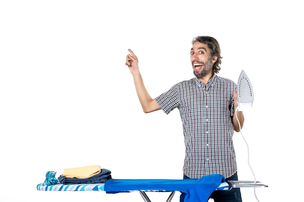 front view young male holding iron on white background housework ironing color machine clean clothes man