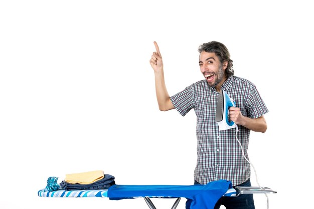 Photo front view young male holding iron on white background ironing color housework clean clothes man home