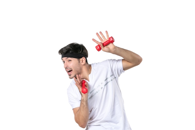 front view young male holding red dumbbells on white background health athlete yoga lifestyle diet sport body human color