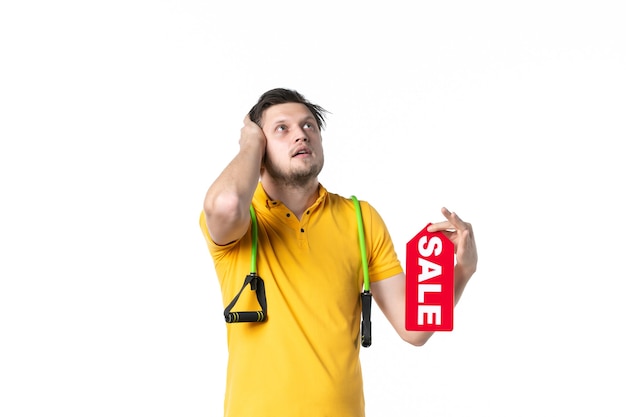 front view young male holding sale written nameplate on white background job sport human shopping salesman worker uniform