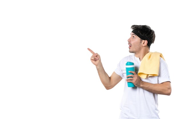 front view young male holding thermos after workout session on white background fit gym yoga health lifestyle sport body diet