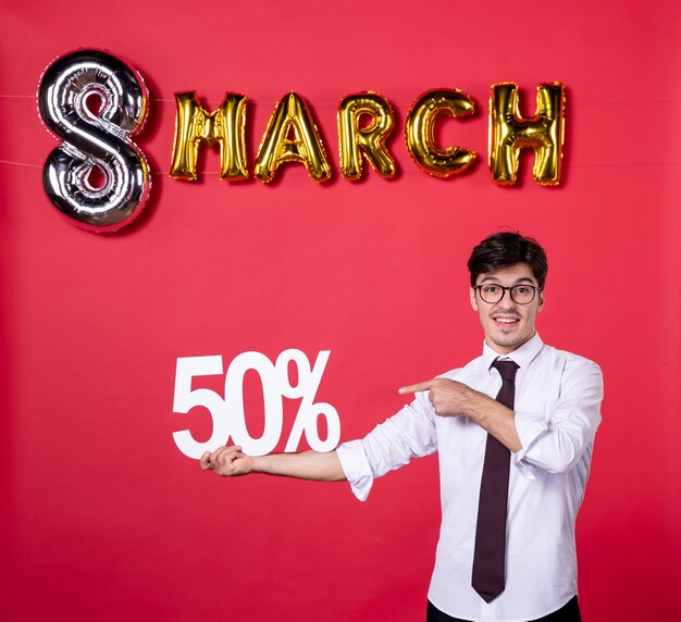 front view young male holding writing on red background present sensual holiday color shopping womans day march woman