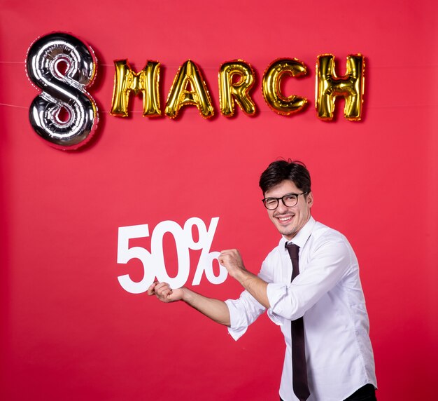 front view young male holding writing on red background shopping vogue woman sensual holiday womans day march present