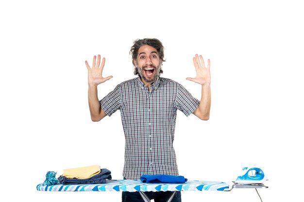 front view young male behind ironing board on white background clean laundry machine man home housework clothes work