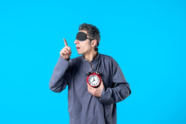 front view young male in pajamas with red clocks on blue background dark nightmare insomnia late dream bed night sleep