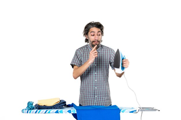 front view young male preparing to iron blue shirt on white background machine man housework work ironing clothes clean