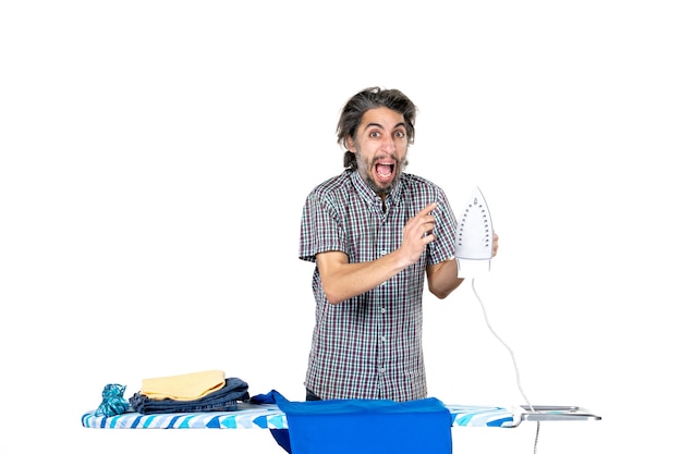 front view young male preparing to iron blue shirt on white background machine man housework work ironing clothes home