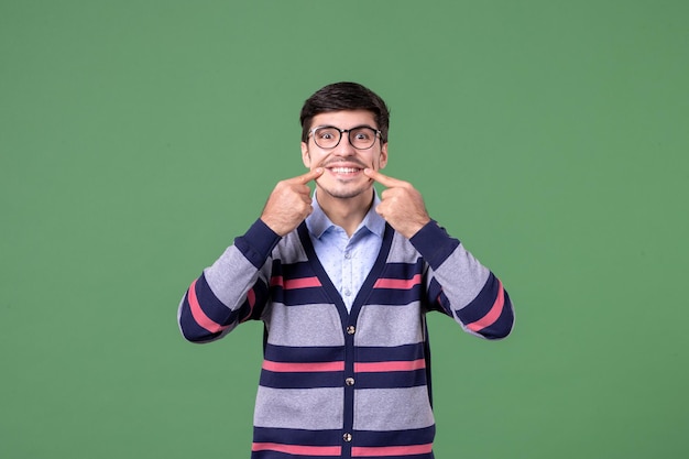 front view young male teacher smiling on green background school student library woman lesson color work university college book