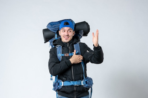 front view young male with backpack going in hiking on white background campaign tent height forest mountain adrenaline sky nature photo