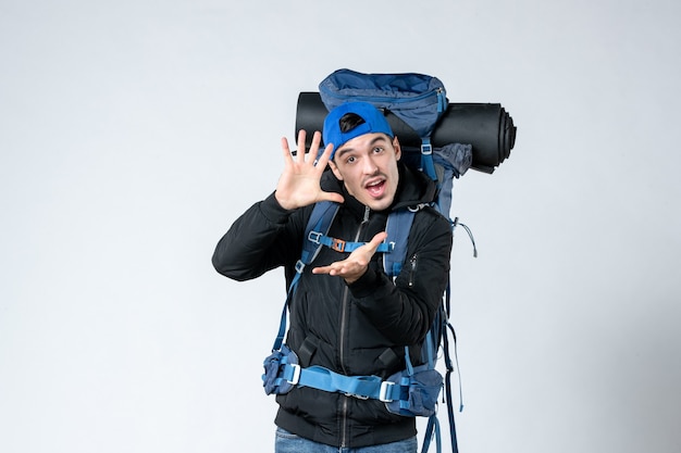 front view young male with backpack on white background campaign sky tent air nature forest snow mountain height