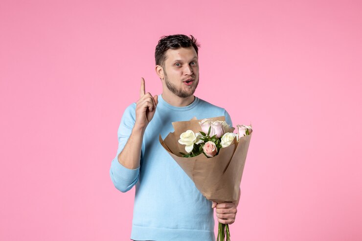 front view young male with bouquet of beautiful flowers on pink background park sensual womens day march feminine date marriage equality love