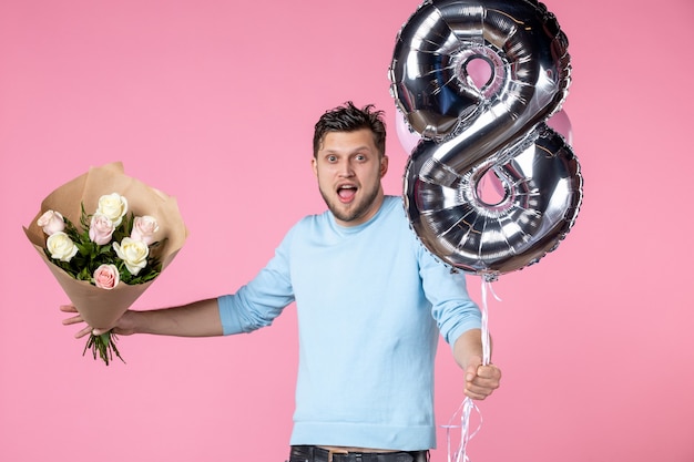 front view young male with flowers and balloons as march present on pink background equality marriage horizontal womens day feminine sensual date