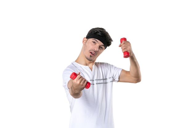 front view young male working out with dumbbells on white background athlete yoga lifestyle diet health sport fit body human