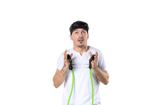 front view young male working out with expander on white background fit athlete gym diet sport body lifestyle hospital regime