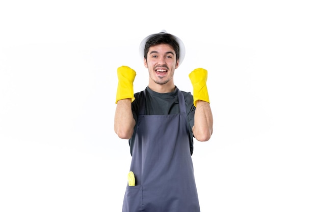 Front view young male in yellow gloves on white background flower garden gardener trees grass bush plant job