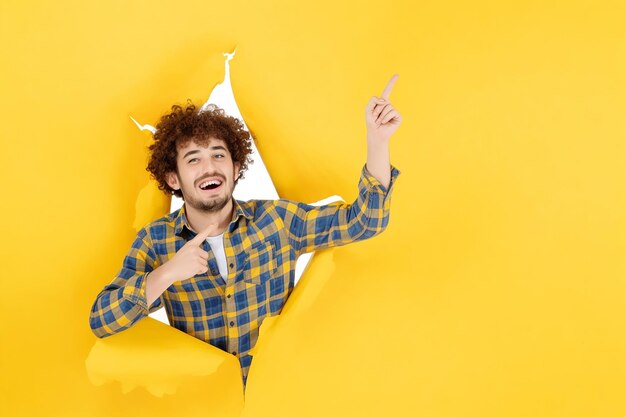 Front view young male on yellow ripped background