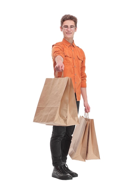 Front view of young man shopping in the mall with many shopping bags in his hand