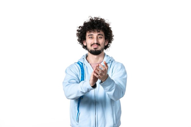 Front view young man with measure tape clapping on white background health muscle human waist weight torso slimming measuring losing body