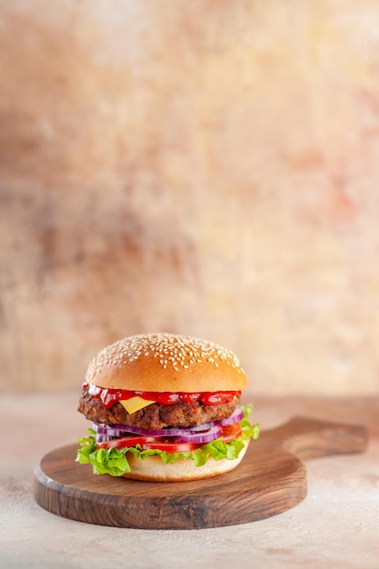 Front view yummy meat cheeseburger on cutting board light background salad dinner snack fast-food sandwich dish burger