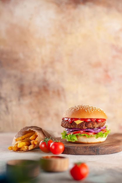 Front view yummy meat cheeseburger on cutting board light surface