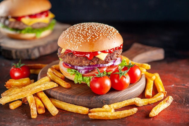 Front view yummy meat cheeseburger with french fries on dark background dinner burger snack fast-food sandwich toasts salad dish